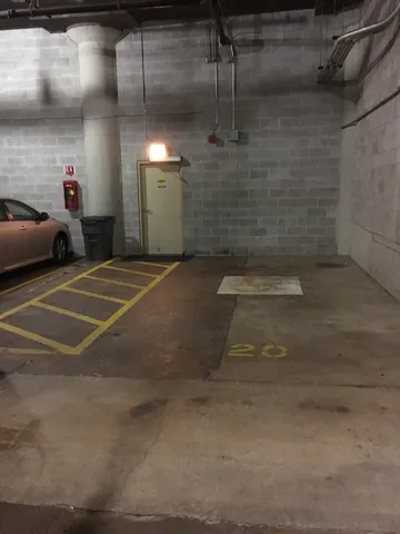 a large kitchen with stainless steel appliances wooden floors and large window