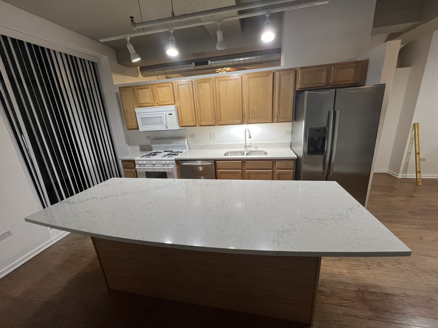 1525 South Sangamon Street, Unit 317P Chicago, IL 60608 - Photo 26 of 27 a large kitchen with a stove a refrigerator a sink and a large window