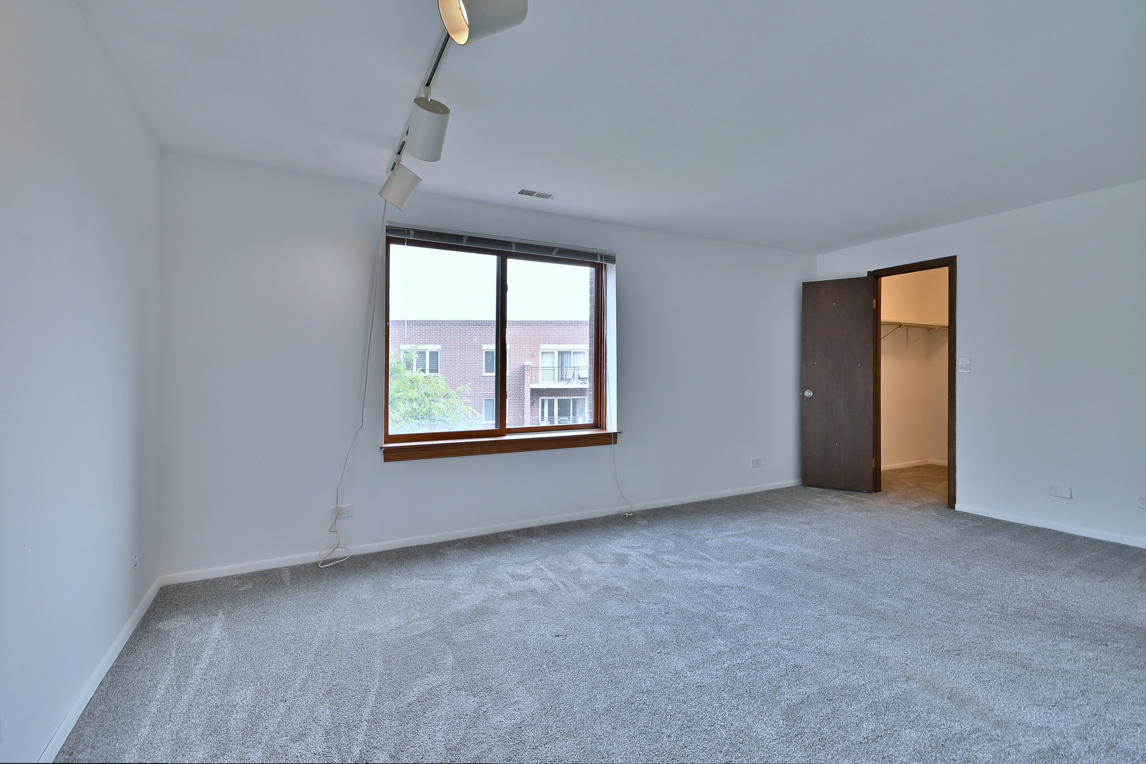 711 South River Road, Unit 508 Des Plaines, IL 60016 - Photo 18 of 41 an empty room with windows