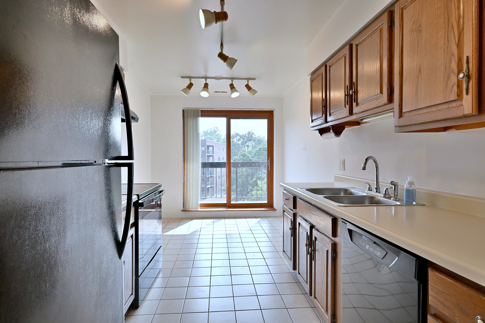 711 South River Road, Unit 508 Des Plaines, IL 60016 - Photo 5 of 41 a kitchen with stainless steel appliances granite countertop a sink stove and refrigerator