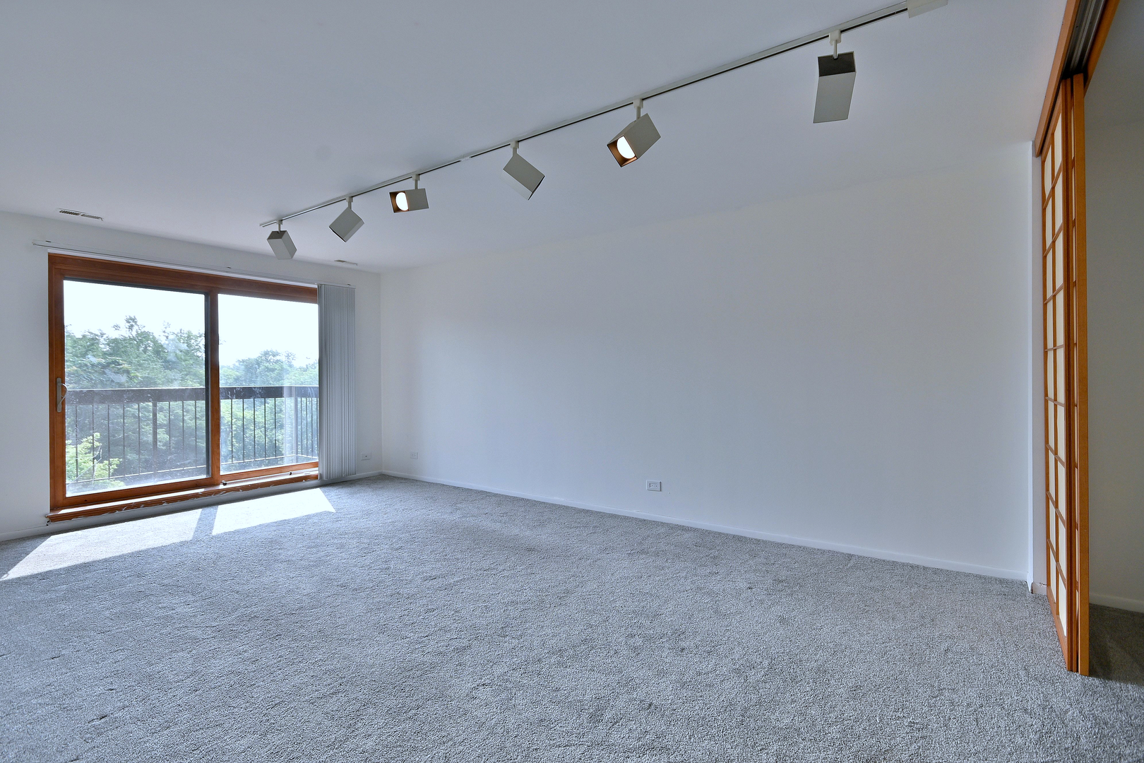 711 South River Road, Unit 508 Des Plaines, IL 60016 - Photo 10 of 41 a view of an empty room with a sliding door