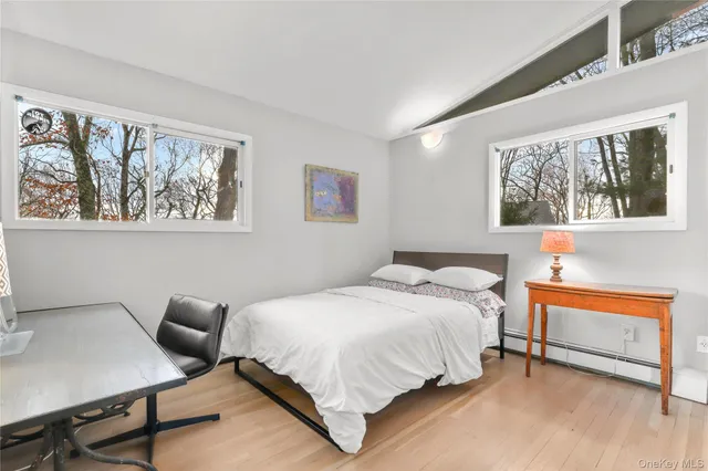 a bedroom with a bed and glass window