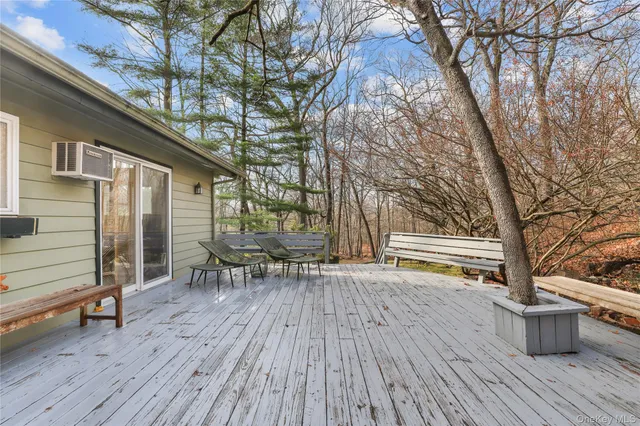 a backyard of a house with wooden floor and outdoor seating
