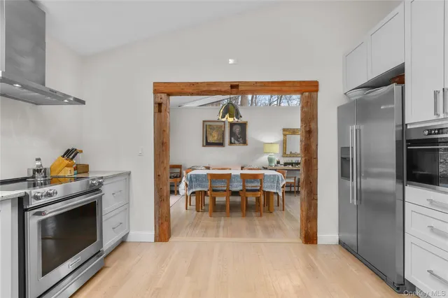 a kitchen with stainless steel appliances granite countertop a stove and a refrigerator