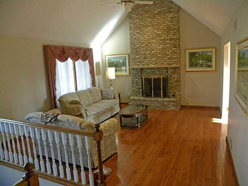 Living Room. Soaring cathedral ceiling in living room with hardwood floor and beautiful fireplace!