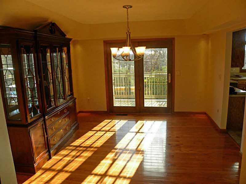 Dining Room. Features tray ceiling with custom lighting and hardwood floor.
