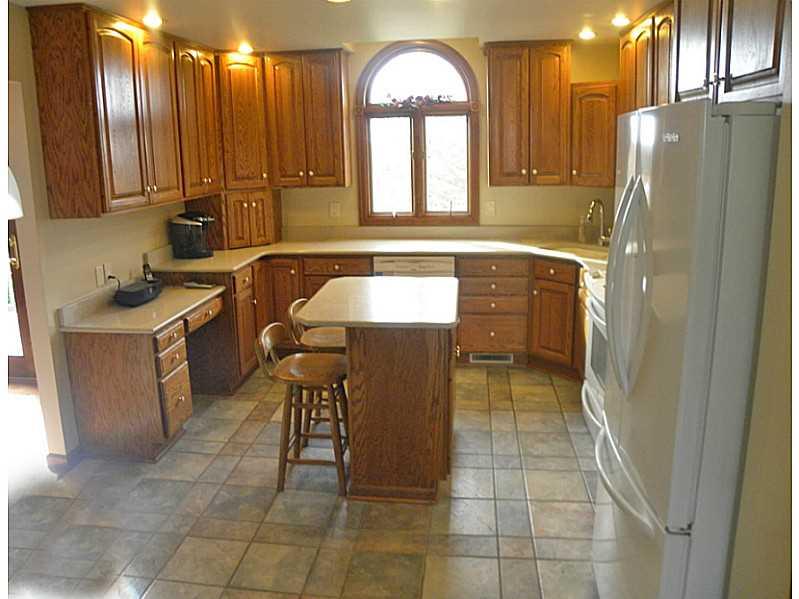 Kitchen. Wow, what a kitchen! Eat Upgraded cabinets, granite countertops, custom lighting and island!
