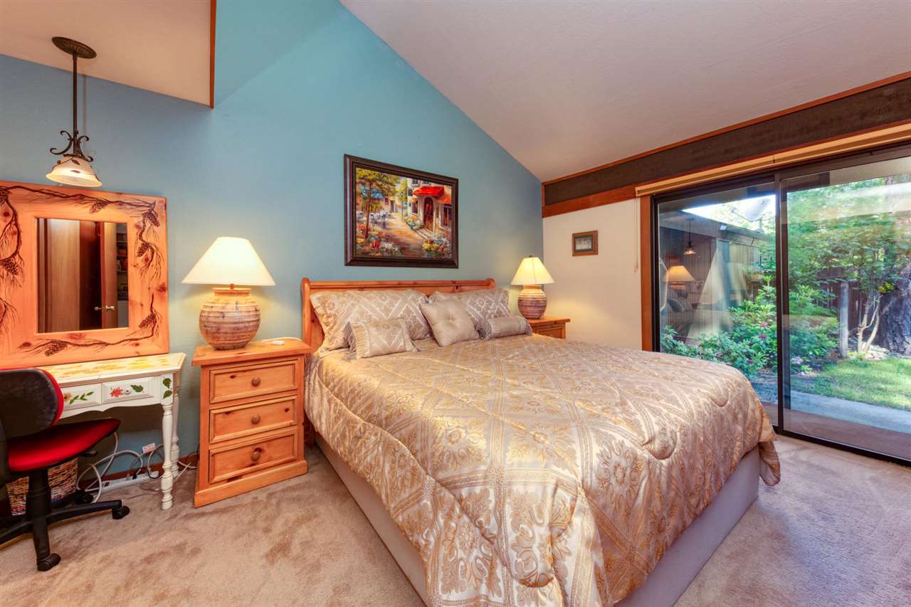 92 Graeagle Meadows Road Graeagle, CA 96103 - Photo 11 of 19 a bedroom with a bed and a dresser next to a window