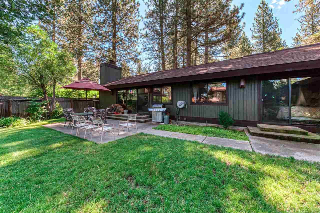 92 Graeagle Meadows Road Graeagle, CA 96103 - Photo 13 of 19 a view of a patio with table and chairs under an umbrella