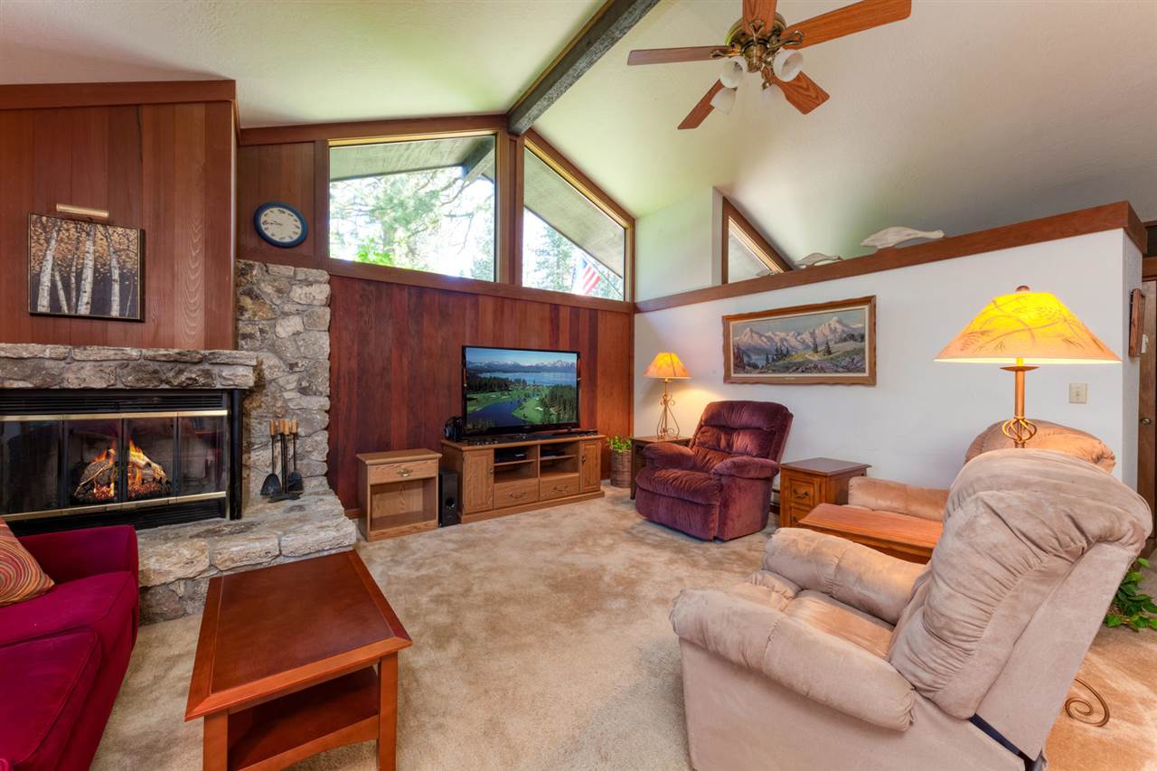 92 Graeagle Meadows Road Graeagle, CA 96103 - Photo 4 of 19 a living room with furniture a flat screen tv and a fireplace
