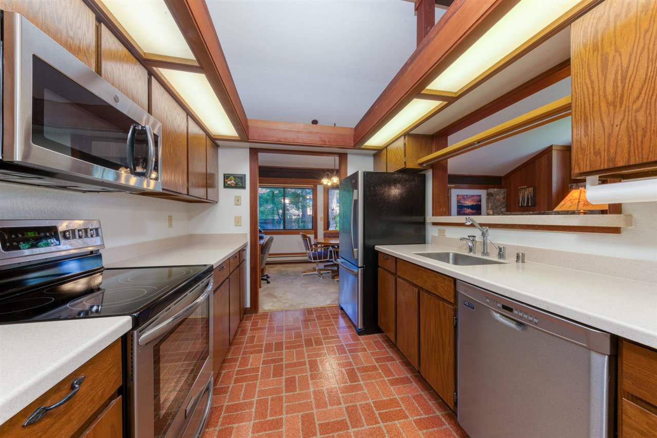 92 Graeagle Meadows Road Graeagle, CA 96103 - Photo 7 of 19 a kitchen with stainless steel appliances granite countertop a sink and wooden cabinets