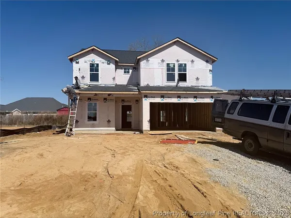 a view of a house with a yard and garage