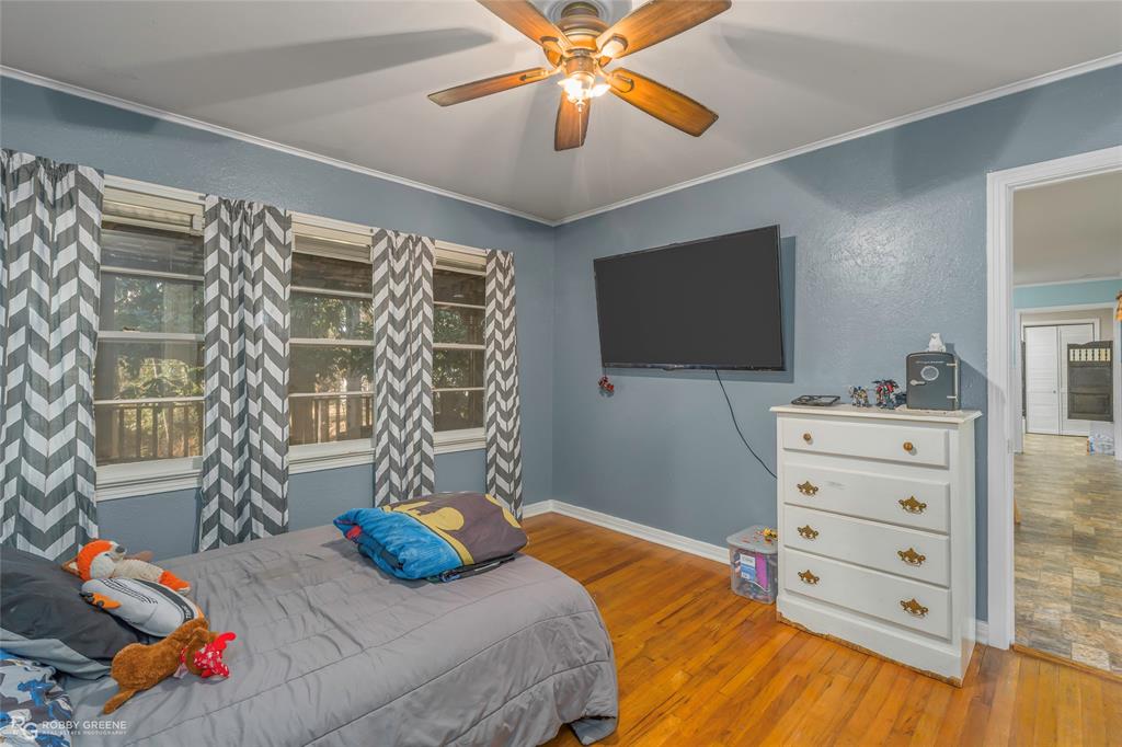 803 Drew Lane Minden, LA 71055 - Photo 20 of 33 a bedroom with a bed and a flat tv screen on dresser