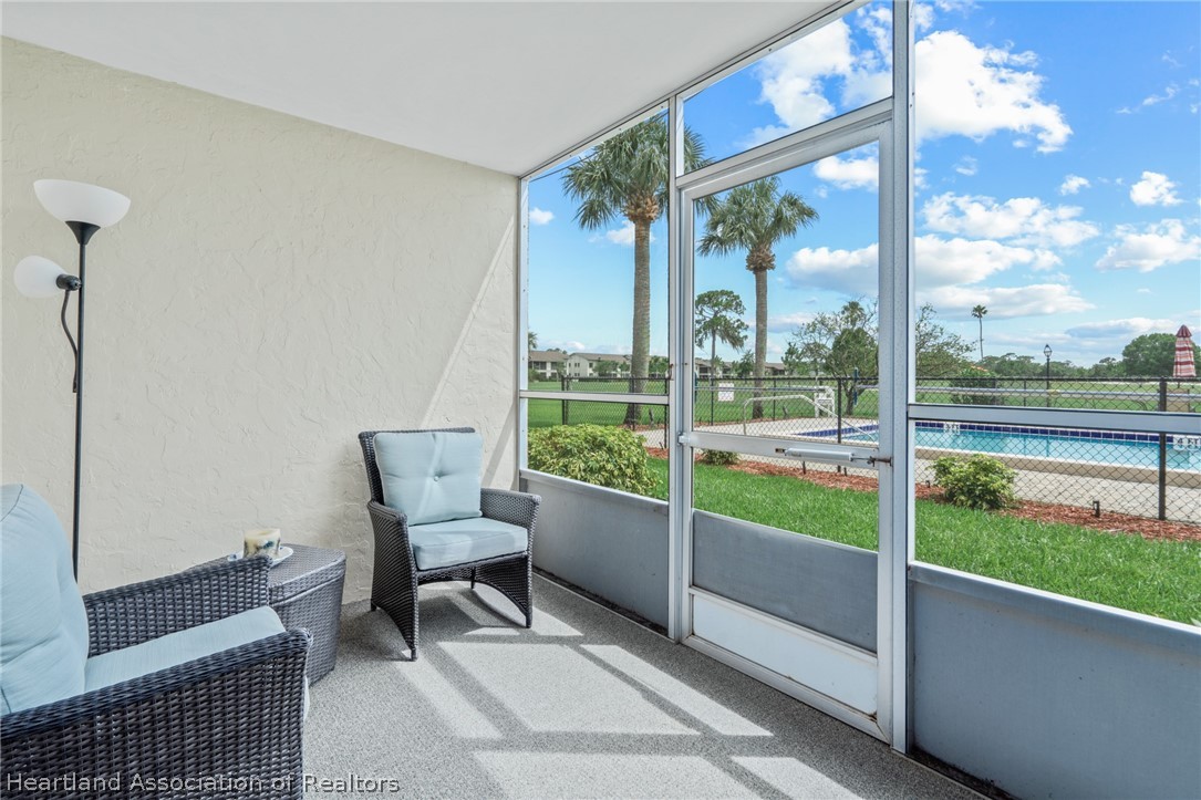 3607 Edgewater Drive Sebring, FL 33872 - Photo 14 of 22 a view of a room with porch and wooden floor