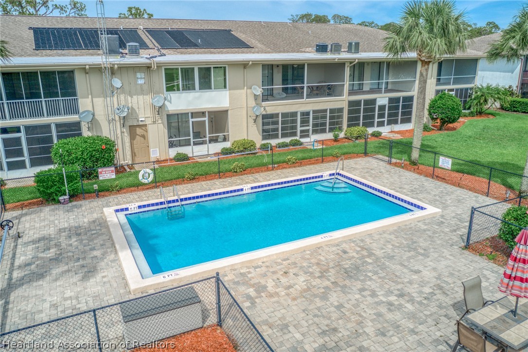 3607 Edgewater Drive Sebring, FL 33872 - Photo 15 of 22 a view of a house with a swimming pool and a yard