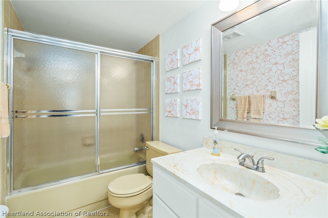 3607 Edgewater Drive Sebring, FL 33872 - Photo 16 of 22 a bathroom with a sink toilet and shower