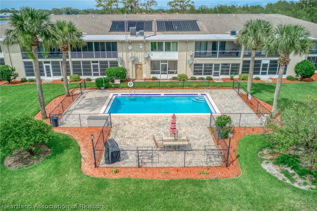 3607 Edgewater Drive Sebring, FL 33872 - Photo 17 of 22 front view of a house with a yard table and chairs