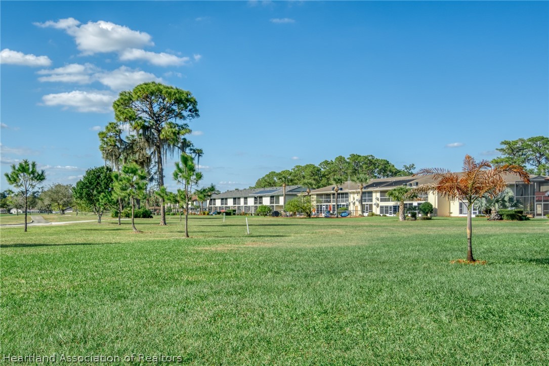 3607 Edgewater Drive Sebring, FL 33872 - Photo 19 of 22 a view of a big room with a big yard and plants