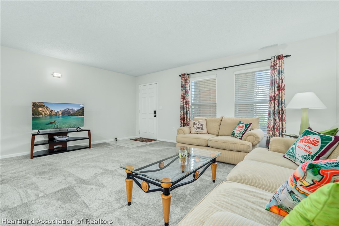 3607 Edgewater Drive Sebring, FL 33872 - Photo 3 of 22 a living room with furniture and a flat screen tv