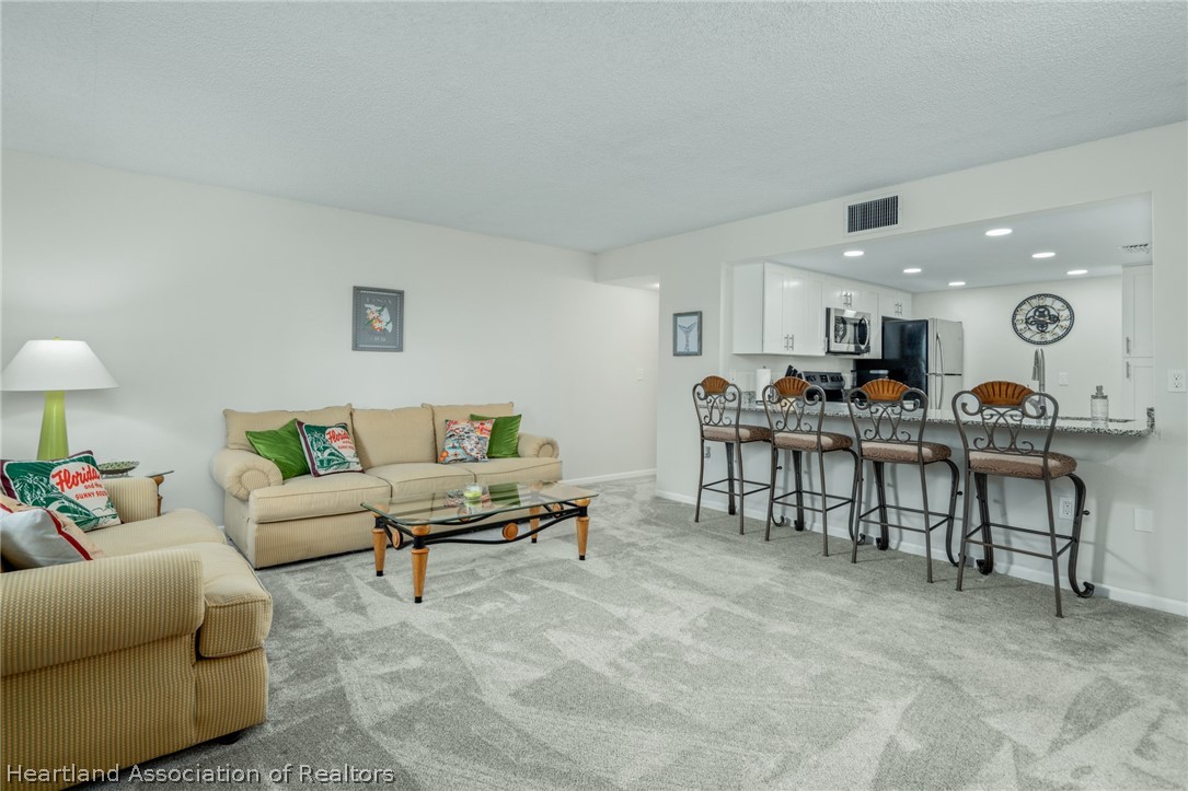 3607 Edgewater Drive Sebring, FL 33872 - Photo 4 of 22 a living room with furniture and kitchen view