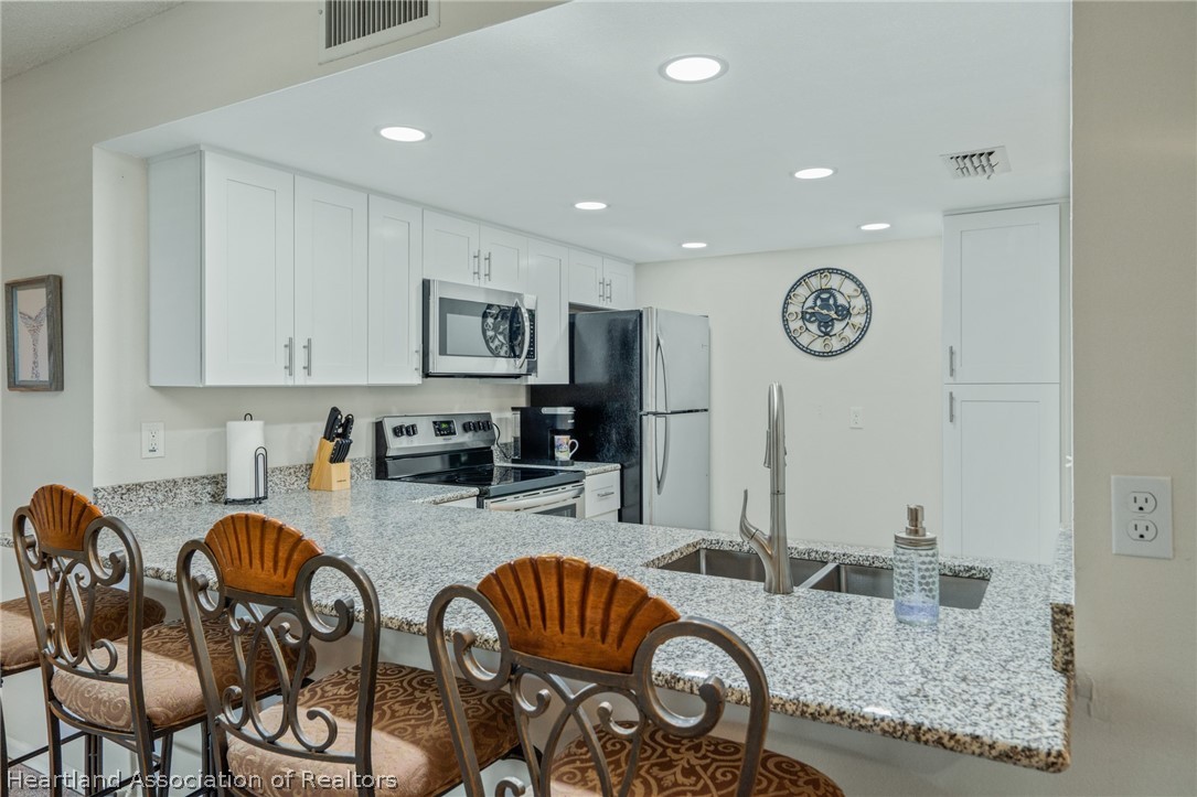3607 Edgewater Drive Sebring, FL 33872 - Photo 5 of 22 a kitchen with sink and view living room
