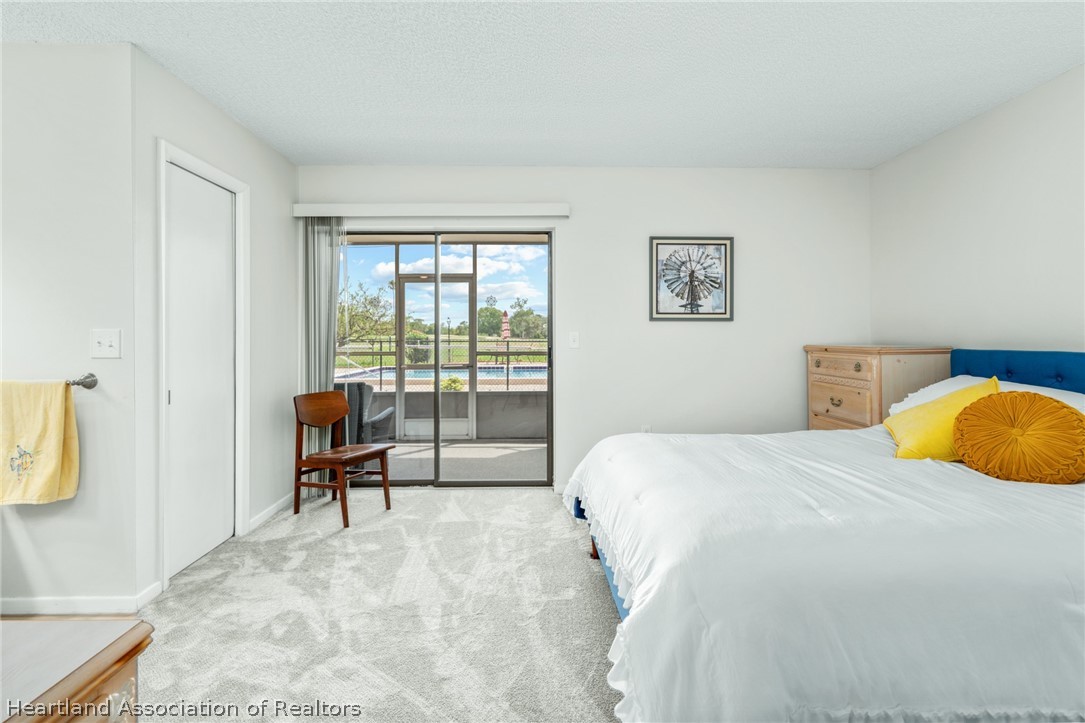 3607 Edgewater Drive Sebring, FL 33872 - Photo 8 of 22 a bedroom with a bed a table and chair