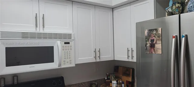a kitchen with cabinets and a fireplace