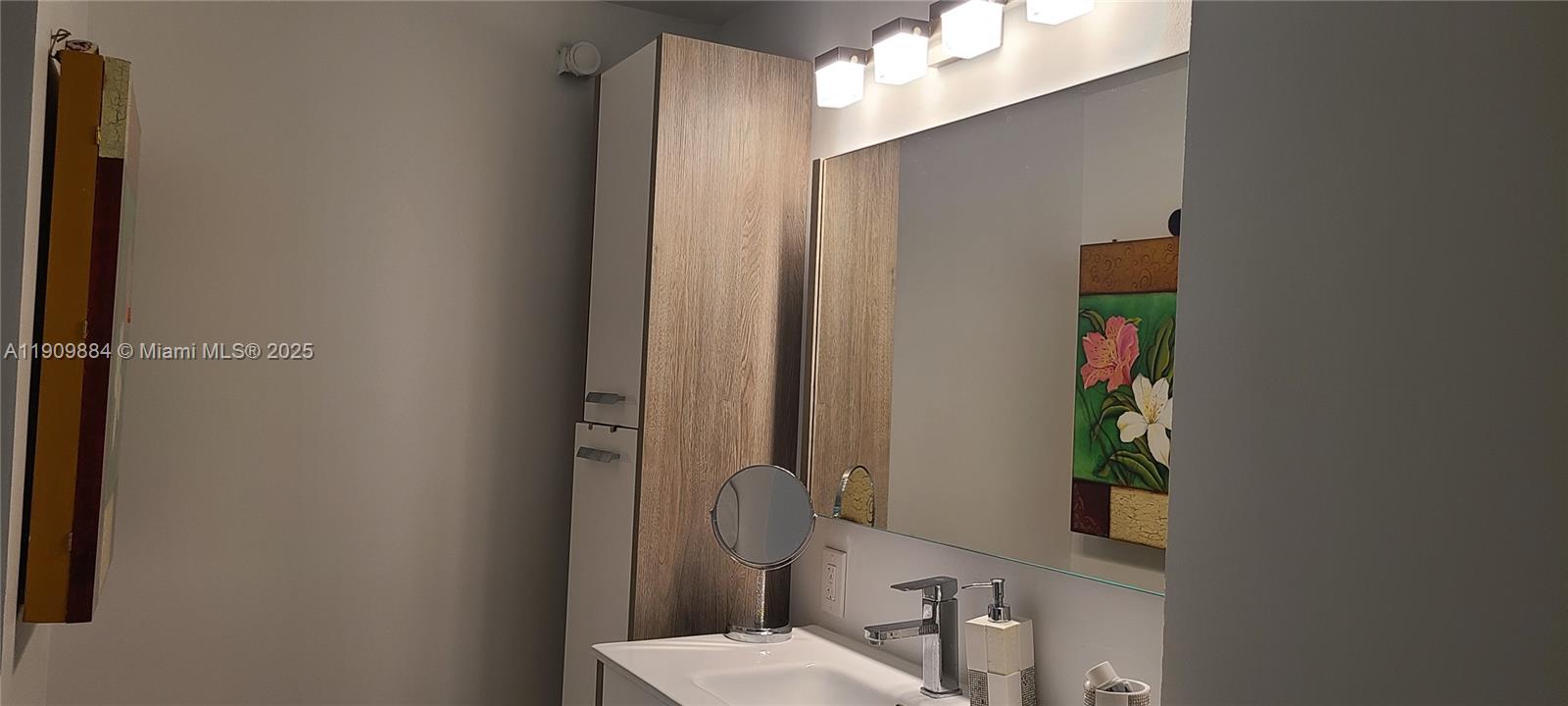 220 Southwest 116th Avenue, Unit 15103 Pembroke Pines, FL 33025 - Photo 23 of 51 a bathroom with a sink and a mirror