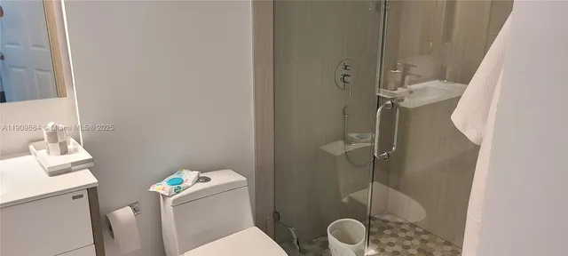 a bathroom with a sink toilet and a mirror