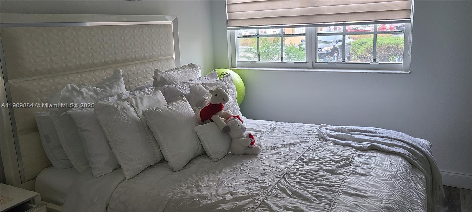 220 Southwest 116th Avenue, Unit 15103 Pembroke Pines, FL 33025 - Photo 32 of 51 a bed sitting in a bedroom next to a window