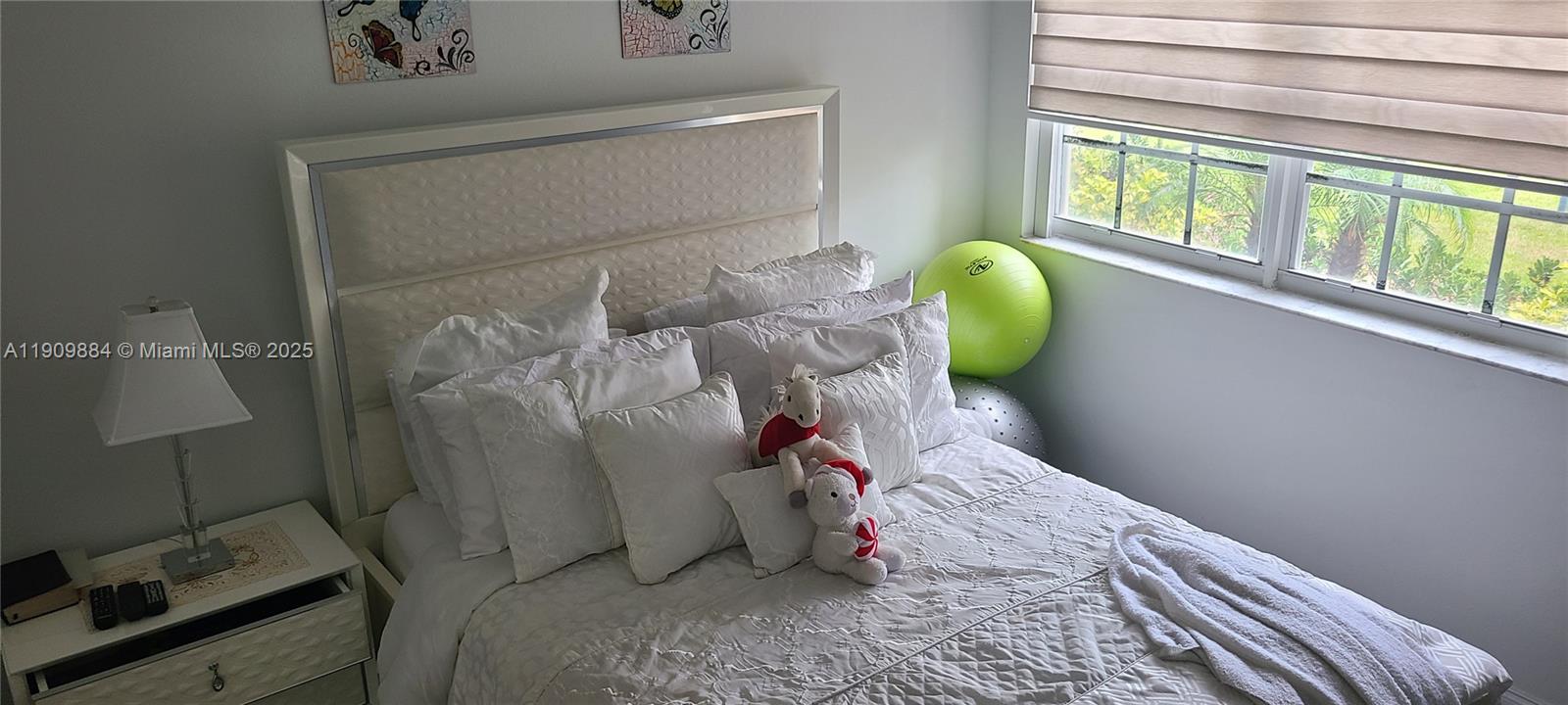 220 Southwest 116th Avenue, Unit 15103 Pembroke Pines, FL 33025 - Photo 34 of 51 a bedroom with a bed and a window