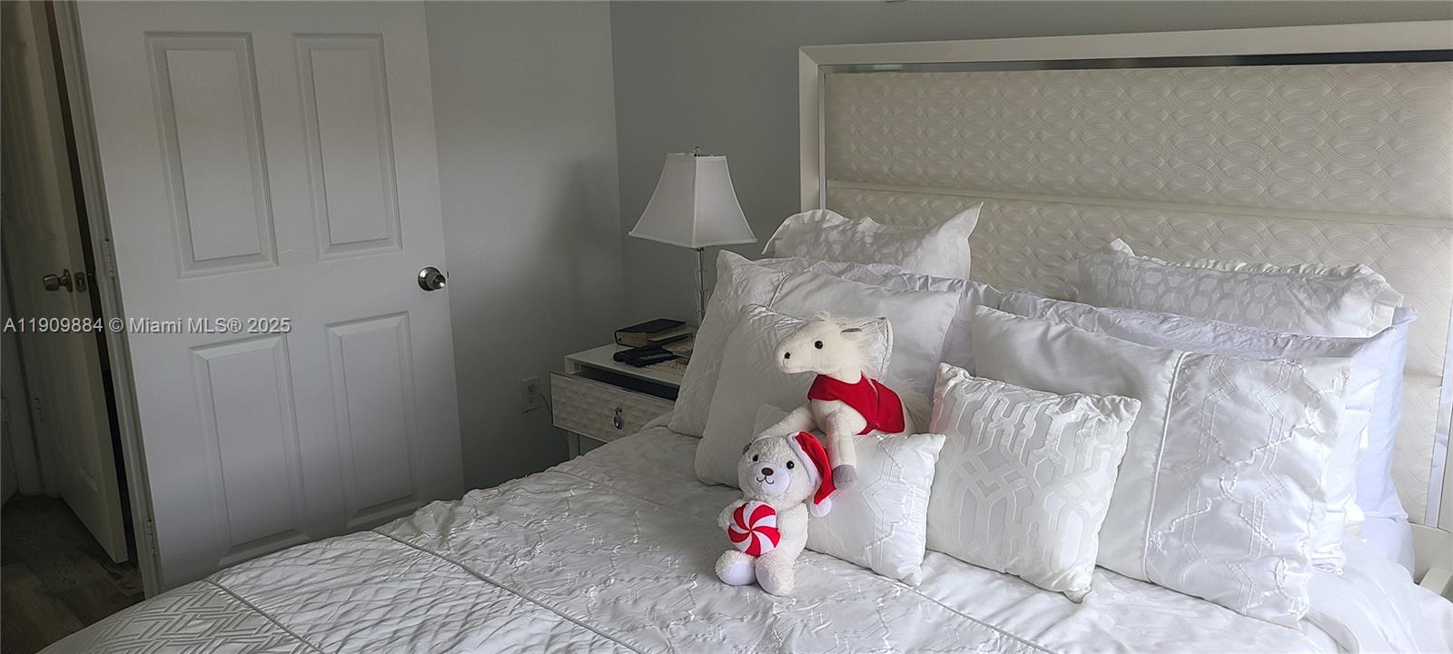 220 Southwest 116th Avenue, Unit 15103 Pembroke Pines, FL 33025 - Photo 35 of 51 a bedroom with a bed and a chandelier