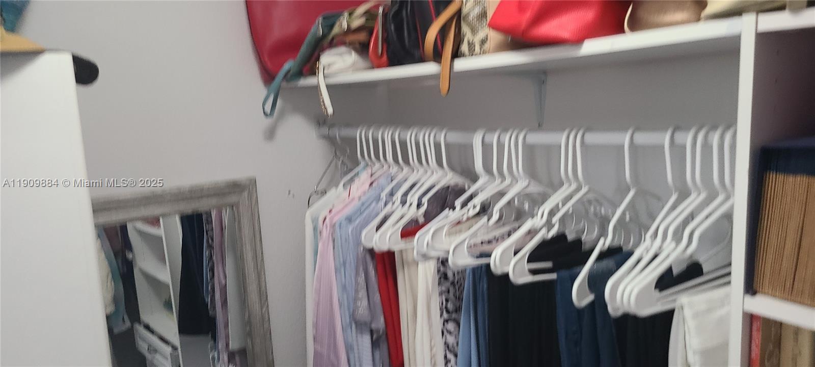 220 Southwest 116th Avenue, Unit 15103 Pembroke Pines, FL 33025 - Photo 37 of 51 a view of walk in closet with clothes and shoes