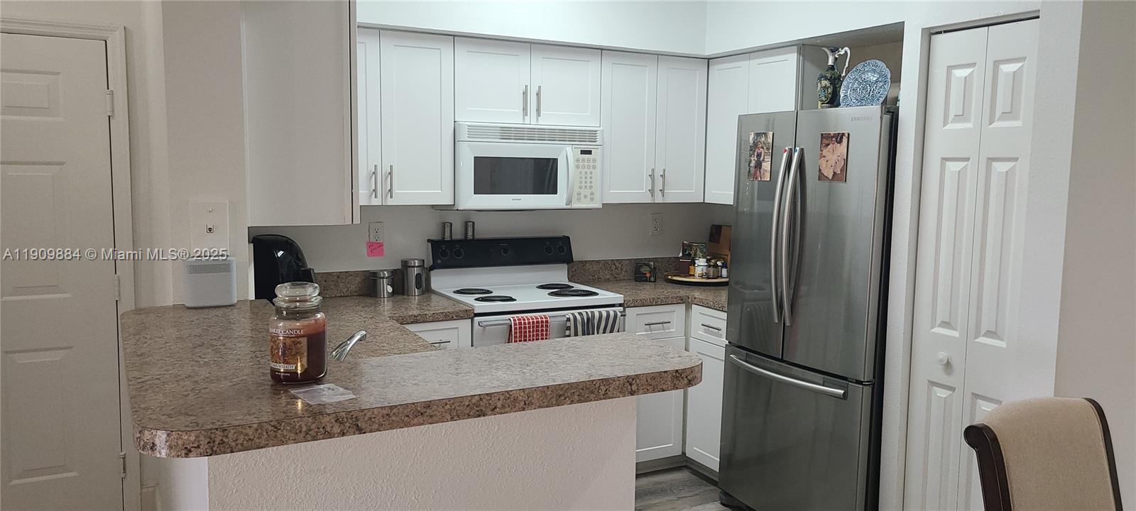 220 Southwest 116th Avenue, Unit 15103 Pembroke Pines, FL 33025 - Photo 4 of 51 a kitchen with stainless steel appliances granite countertop a refrigerator a stove and a sink