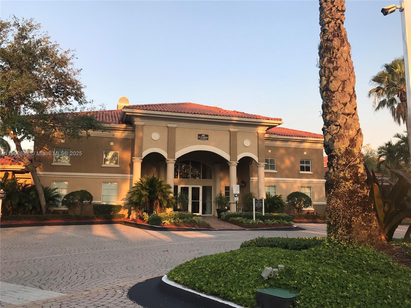 220 Southwest 116th Avenue, Unit 15103 Pembroke Pines, FL 33025 - Photo 45 of 51 a front view of a house with a yard