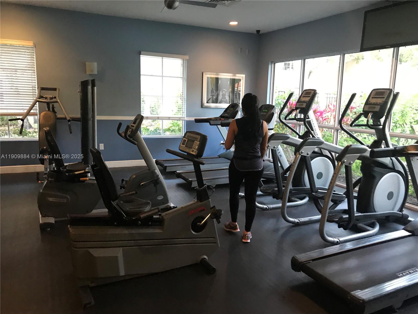 220 Southwest 116th Avenue, Unit 15103 Pembroke Pines, FL 33025 - Photo 49 of 51 a view of a room with gym equipment