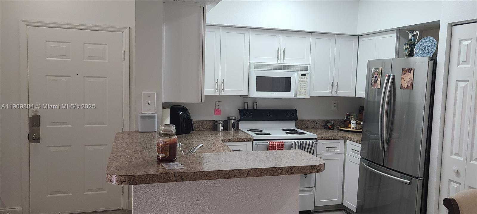 220 Southwest 116th Avenue, Unit 15103 Pembroke Pines, FL 33025 - Photo 6 of 51 a kitchen with stainless steel appliances granite countertop a refrigerator stove and sink