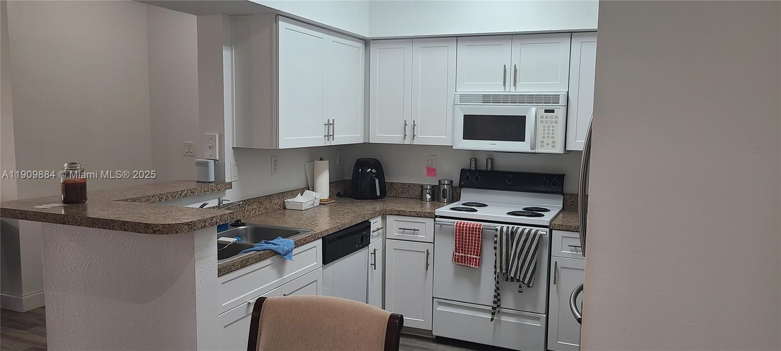 220 Southwest 116th Avenue, Unit 15103 Pembroke Pines, FL 33025 - Photo 9 of 51 a kitchen with stainless steel appliances granite countertop a sink stove and refrigerator