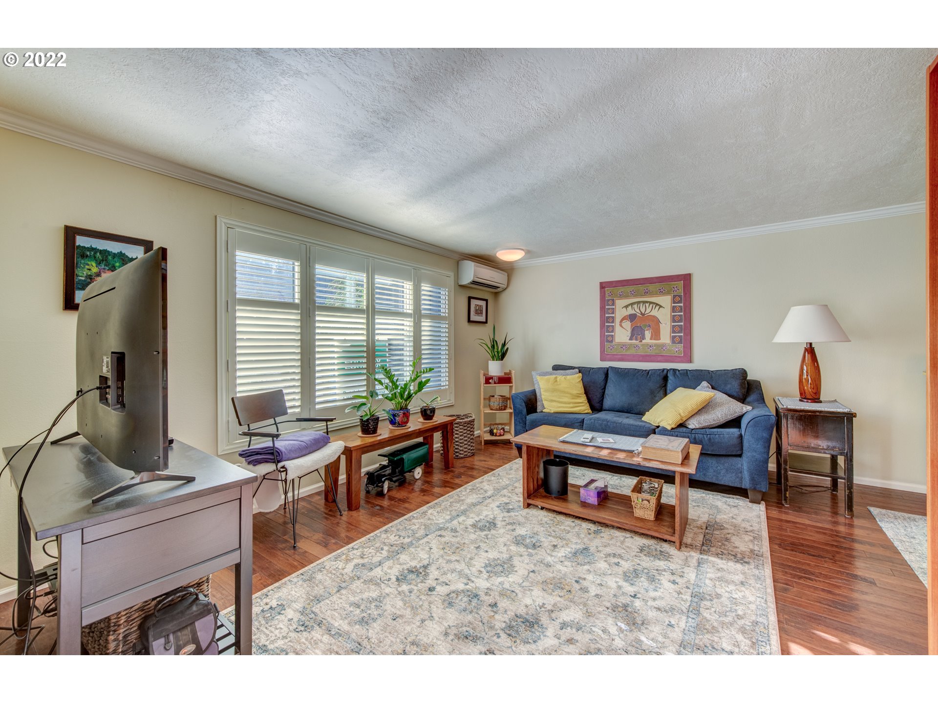 43 Westbrook Way Eugene, OR 97405 - Photo 4 of 32 a living room with furniture a window and a flat screen tv