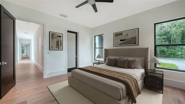 a bedroom with a large bed and a window