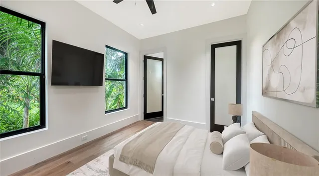 a bedroom with a bed and a large window