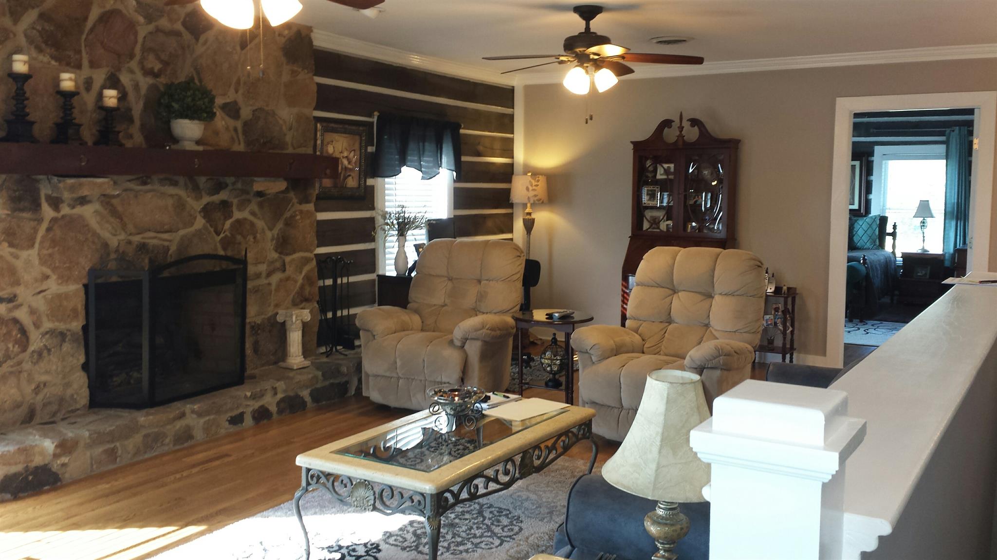 555 Windy Ridge Wartrace, TN 37183 - Photo 5 of 23 Living room with rock wood burning fireplace and hardwood floors.