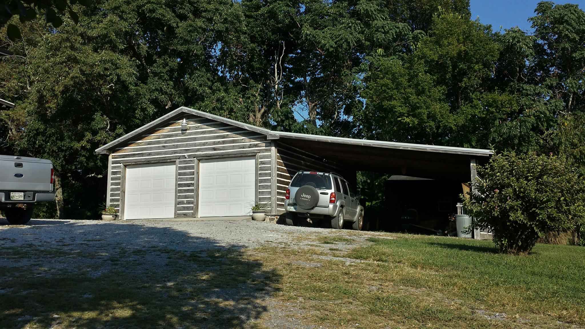 555 Windy Ridge Wartrace, TN 37183 - Photo 6 of 23 Front view of two car garage with attached large carport with storage building in back