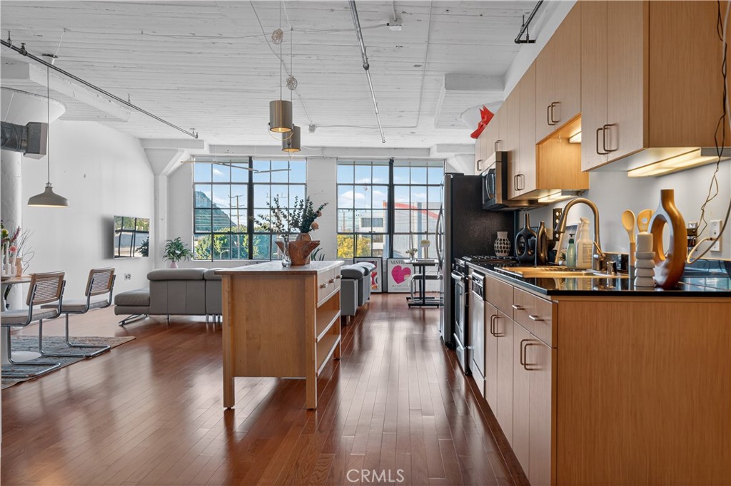 200 North San Fernando Road, Unit 315 Los Angeles, CA 90031 - Photo 1 of 42 a living room with stainless steel appliances granite countertop lots of wooden furniture large window wooden floor and stuff