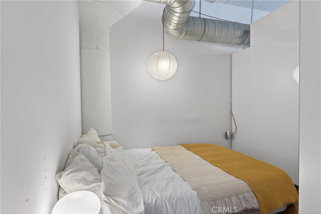 200 North San Fernando Road, Unit 315 Los Angeles, CA 90031 - Photo 20 of 42 a bedroom with a bed and a chandelier fan