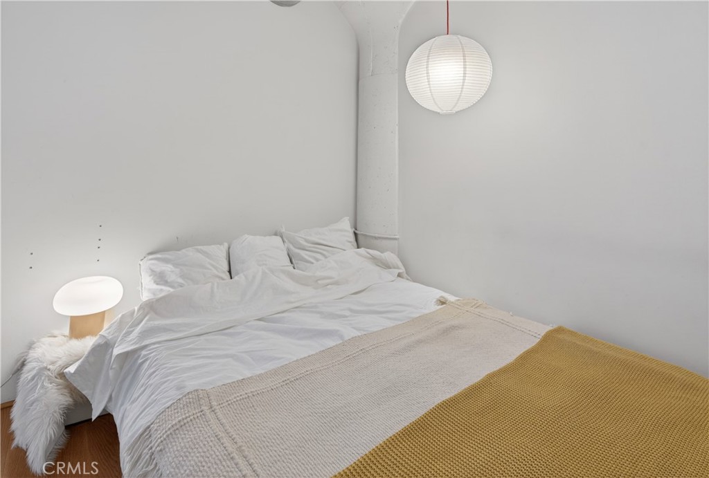 200 North San Fernando Road, Unit 315 Los Angeles, CA 90031 - Photo 21 of 42 a bedroom with a bed and a chandelier