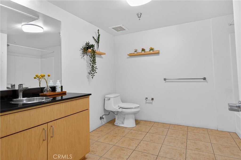 200 North San Fernando Road, Unit 315 Los Angeles, CA 90031 - Photo 23 of 42 a bathroom with a sink a toilet and mirror