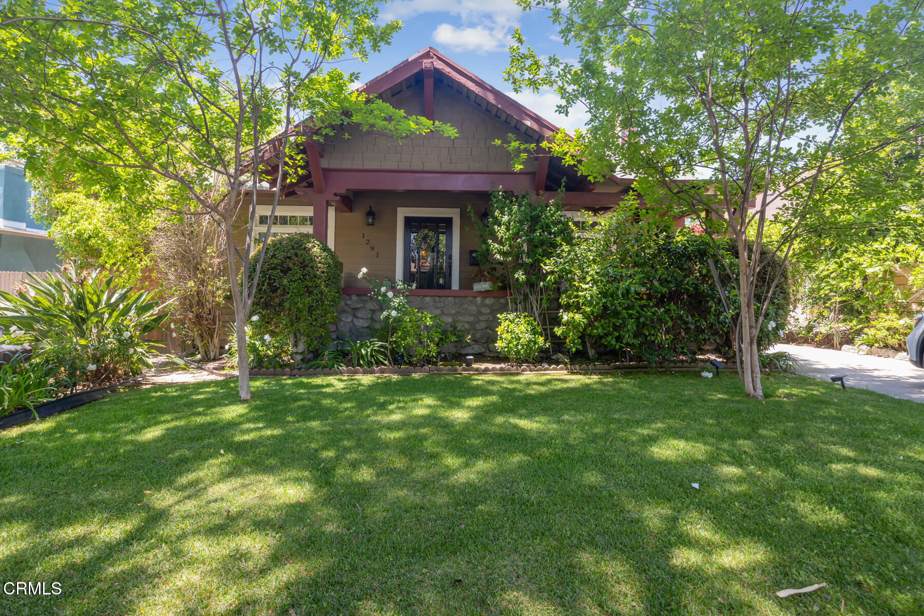 a front view of a house with a garden