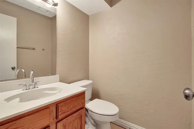 a bathroom with a sink a toilet and a mirror