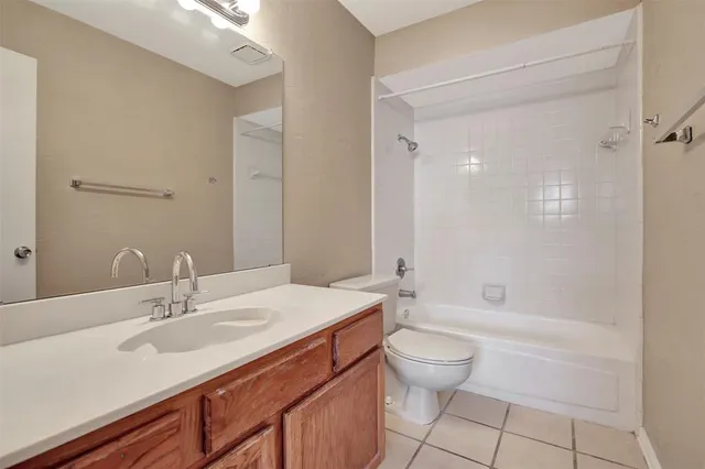 a bathroom with a sink a toilet and a large mirror